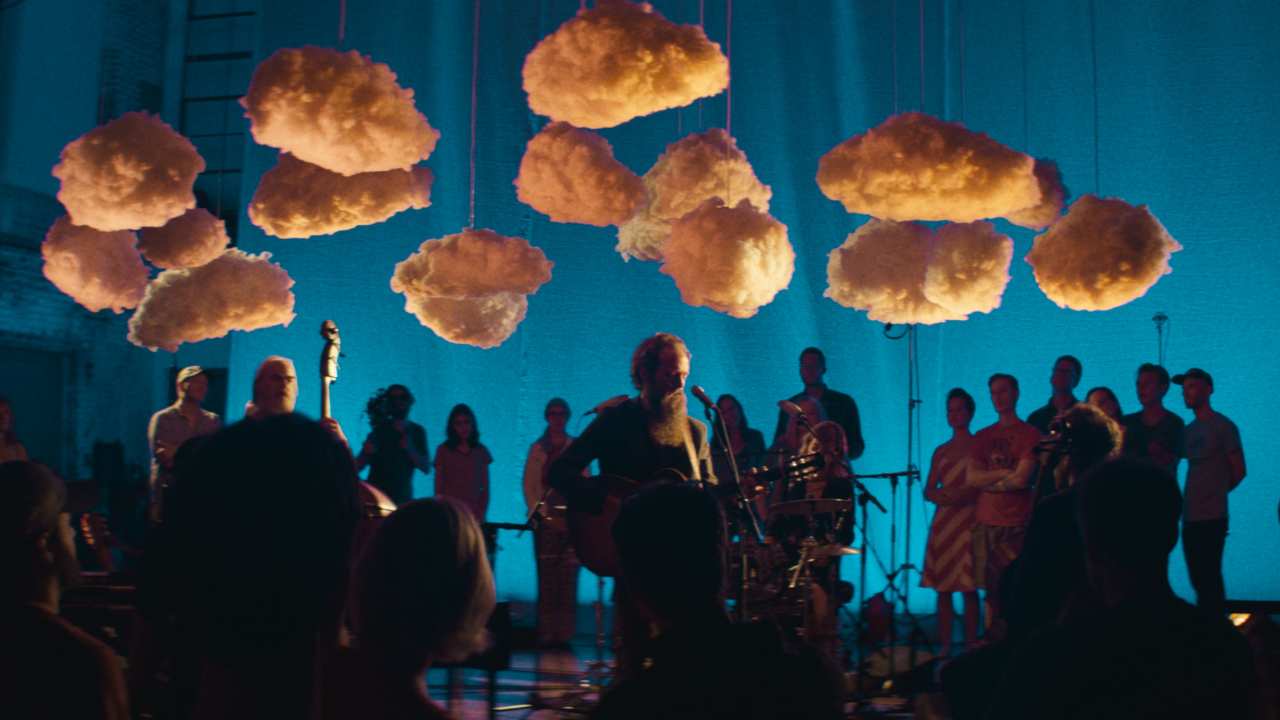 people playing music with clouds suspended above